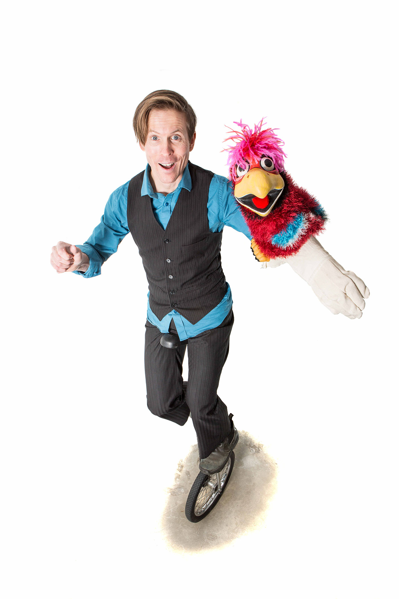 Tim on unicycle with parrot puppet